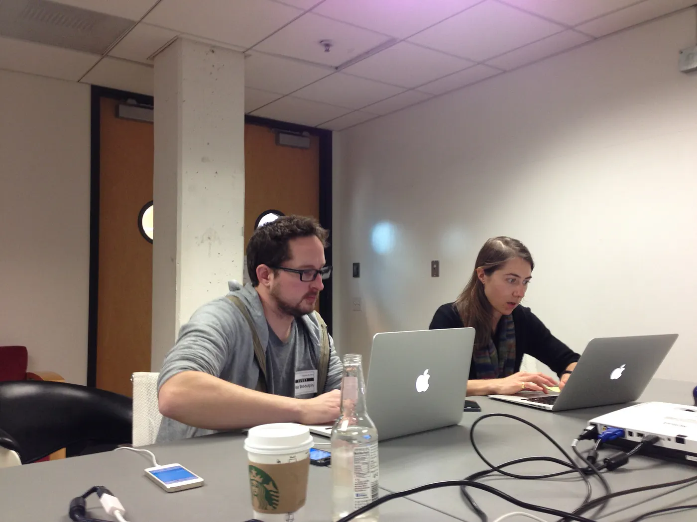 Matt Biddulph and Janie Lorber working on laptops while preparing UP Coffee for App Store submission.